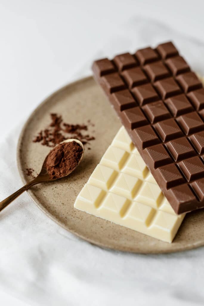 bars of white and dark chocolate with cocoa powder