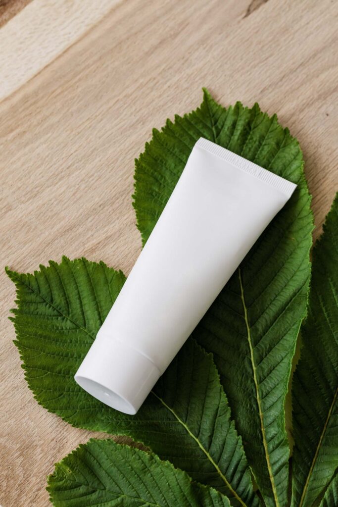 Toiletry laying on a green leaf to represent a natural product